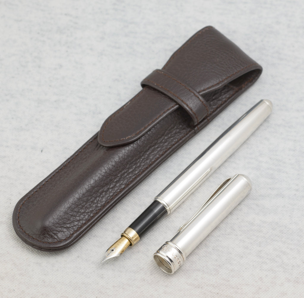 Vintage Links of London silver plated fountain pen beside its original brown leather pouch