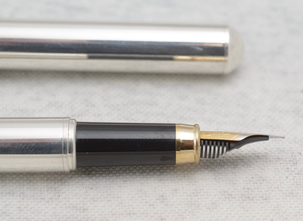 Links of London fountain pen and cap beside the open original brown leather pouch
