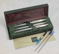Boxed Cross Medalist writing set with three chrome and gold tone pens, original case, paperwork, converter, cartridge and spare refills