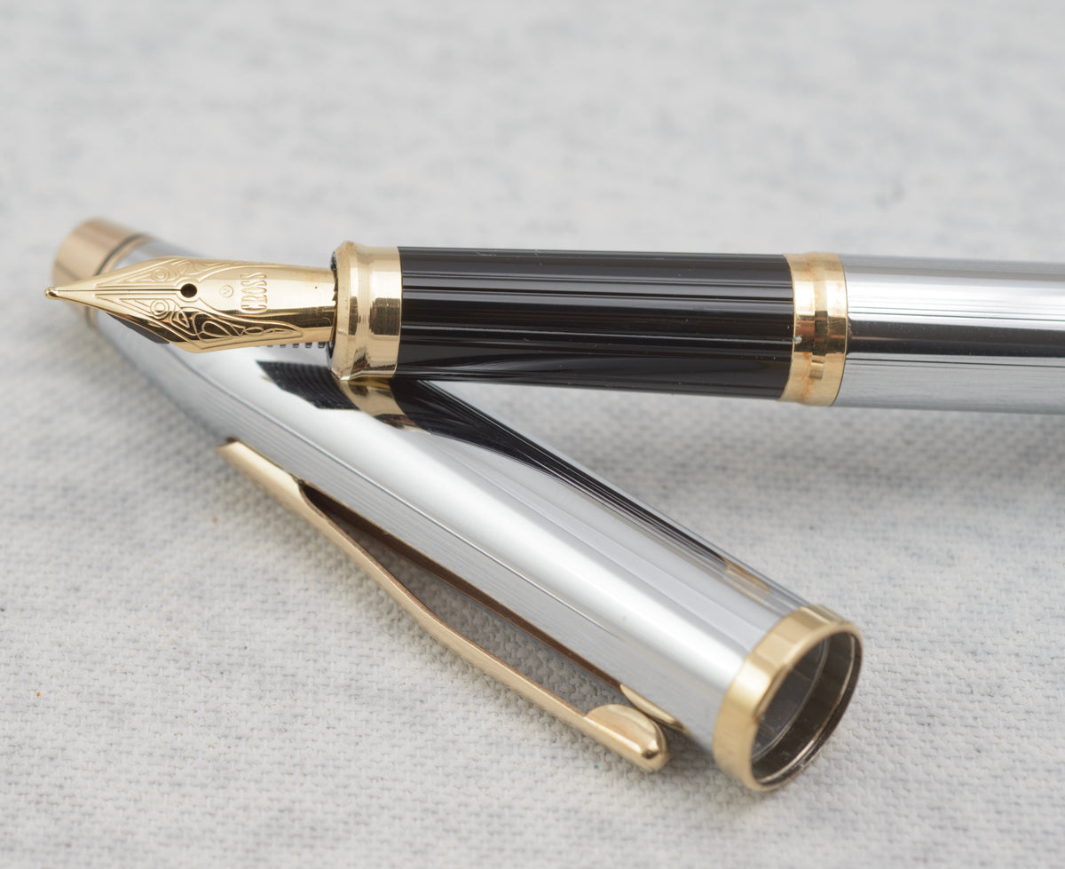 Close view of the decorative gold tone Cross nib and black grip section on the Century II fountain pen