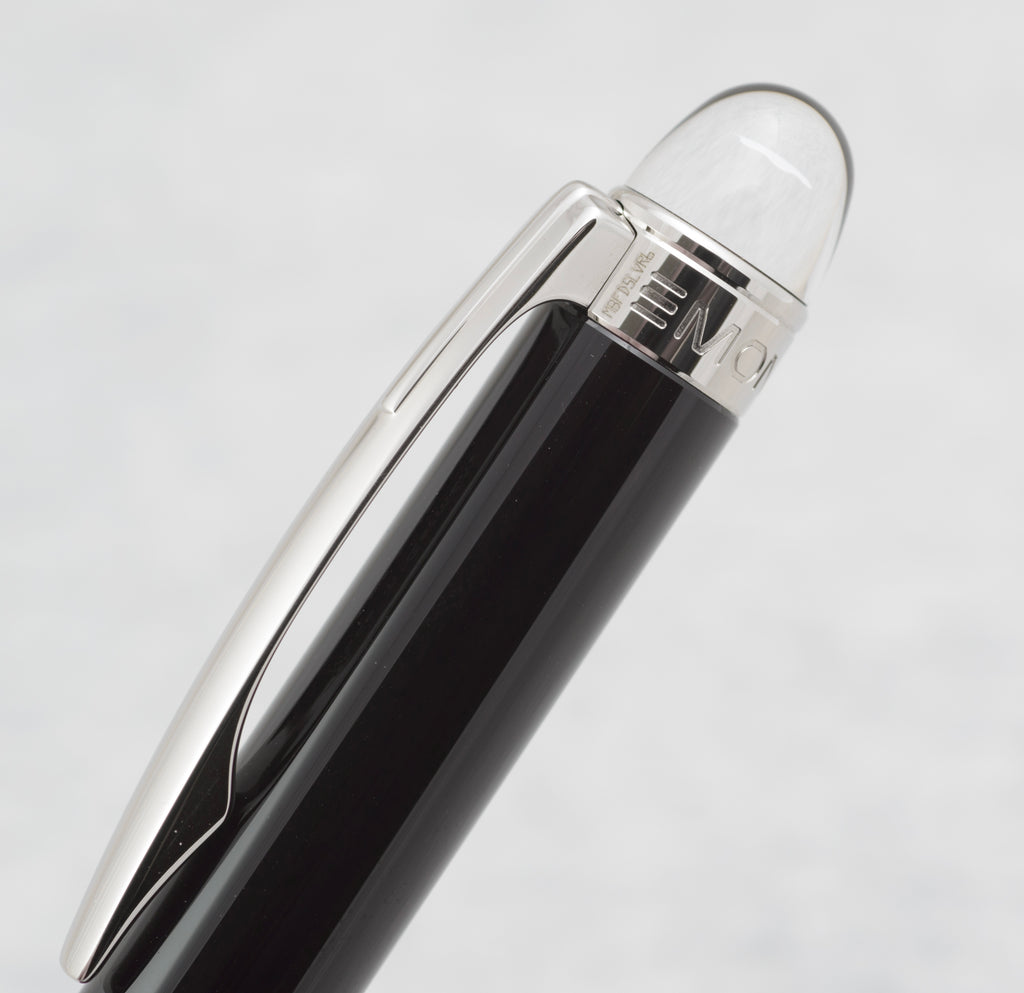 White Montblanc emblem appearing suspended inside the clear domed finial of the StarWalker pencil