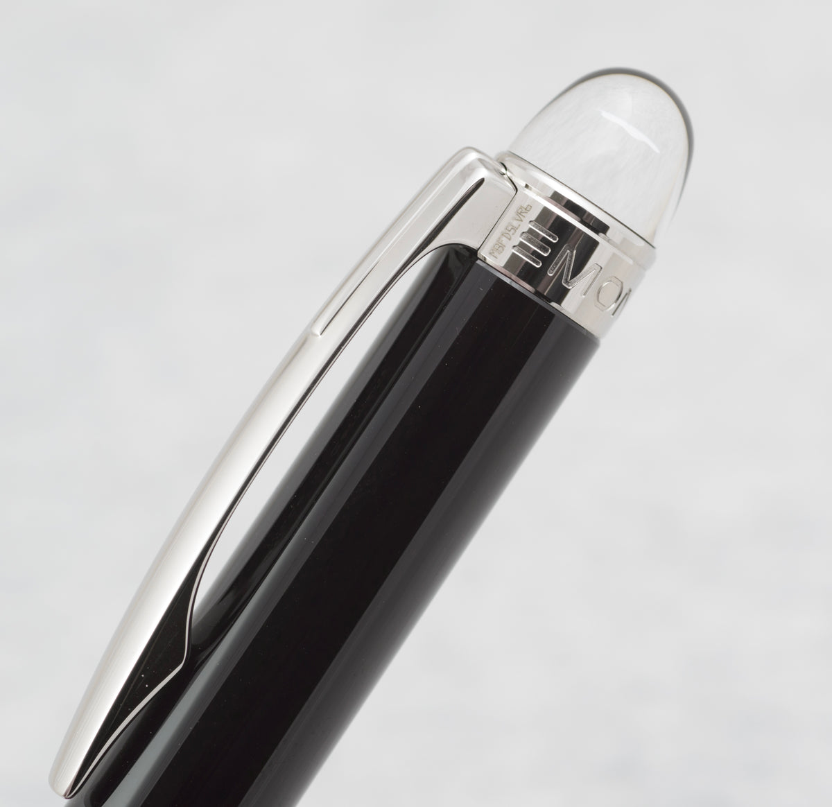 White Montblanc emblem appearing suspended inside the clear domed finial of the StarWalker pencil