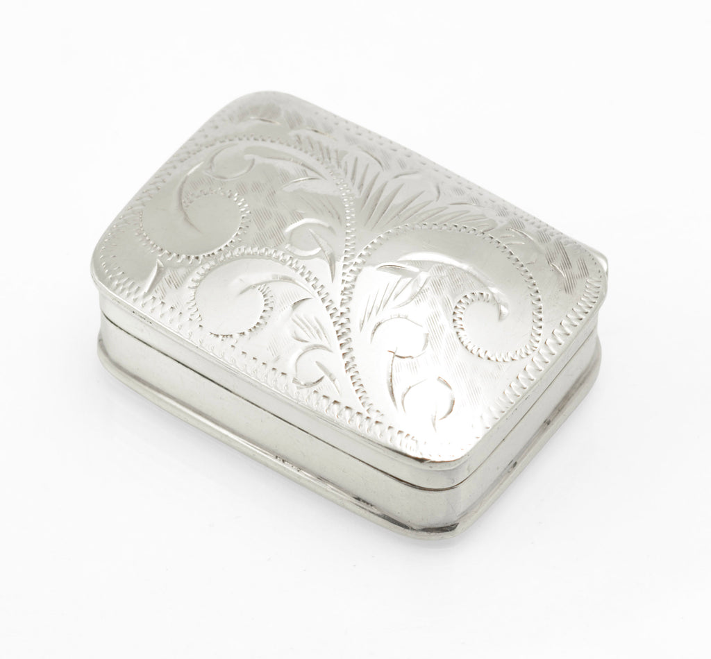 Engraved lid of the sterling silver pill box with scrolling acanthus style foliage