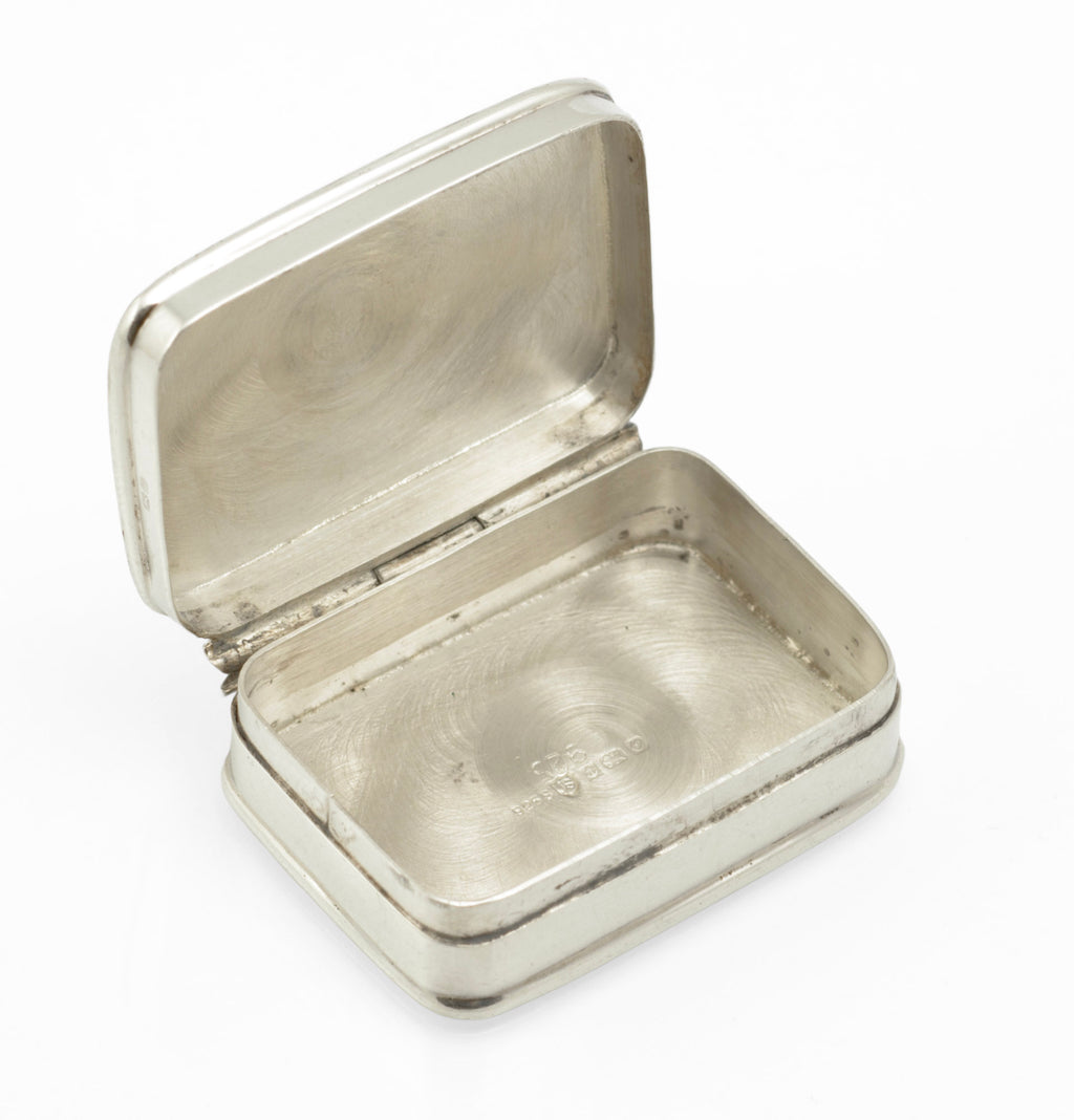Angled view of the engraved acanthus style foliage across the pill box lid