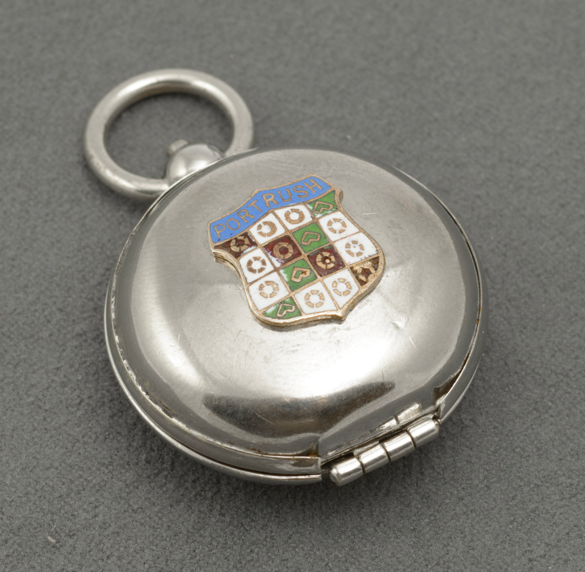 Open J.W. Benson sovereign holder showing the hinged cover, spring loaded carrier and suspension ring