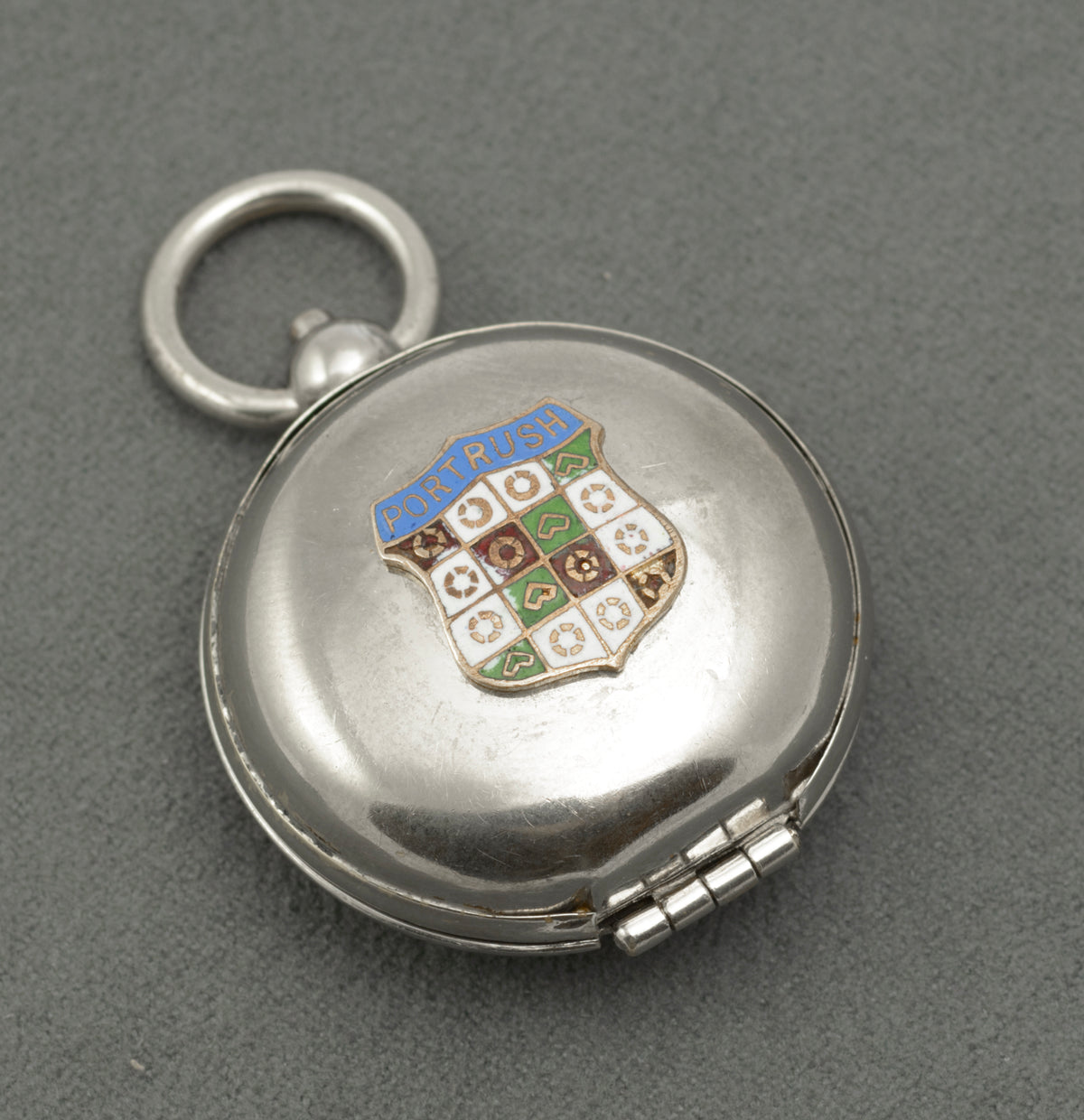 Open sovereign holder viewed from the opposite side, showing its coin carrier and hinged cover