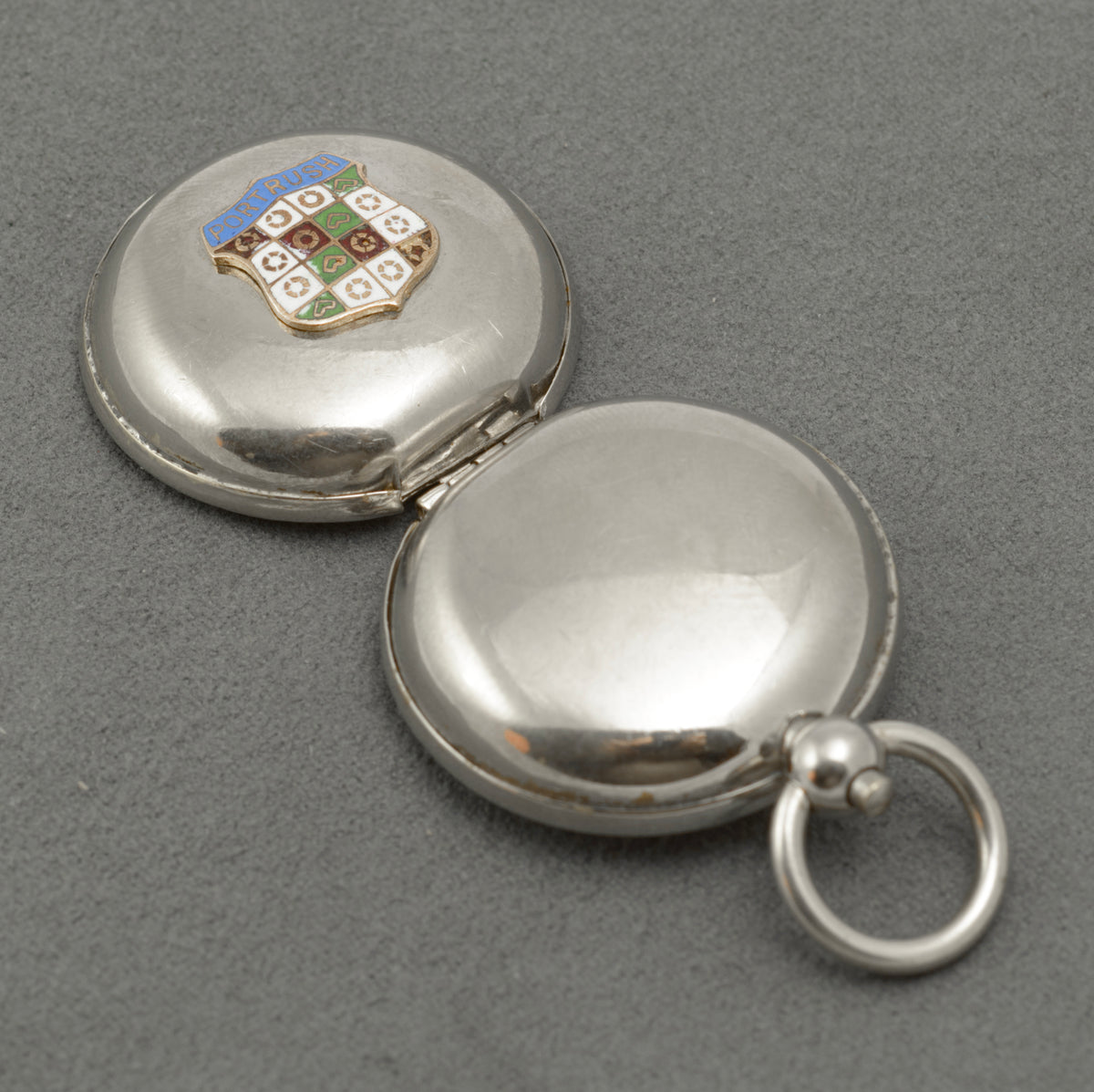 Open sovereign holder showing the hinged case and internal coin carrier