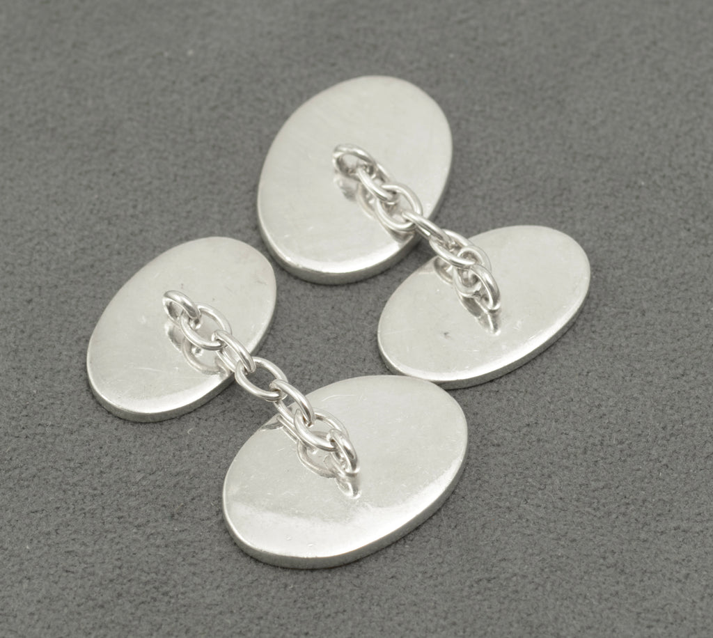 Front and reverse panels of the sterling silver cufflinks with their connecting chains