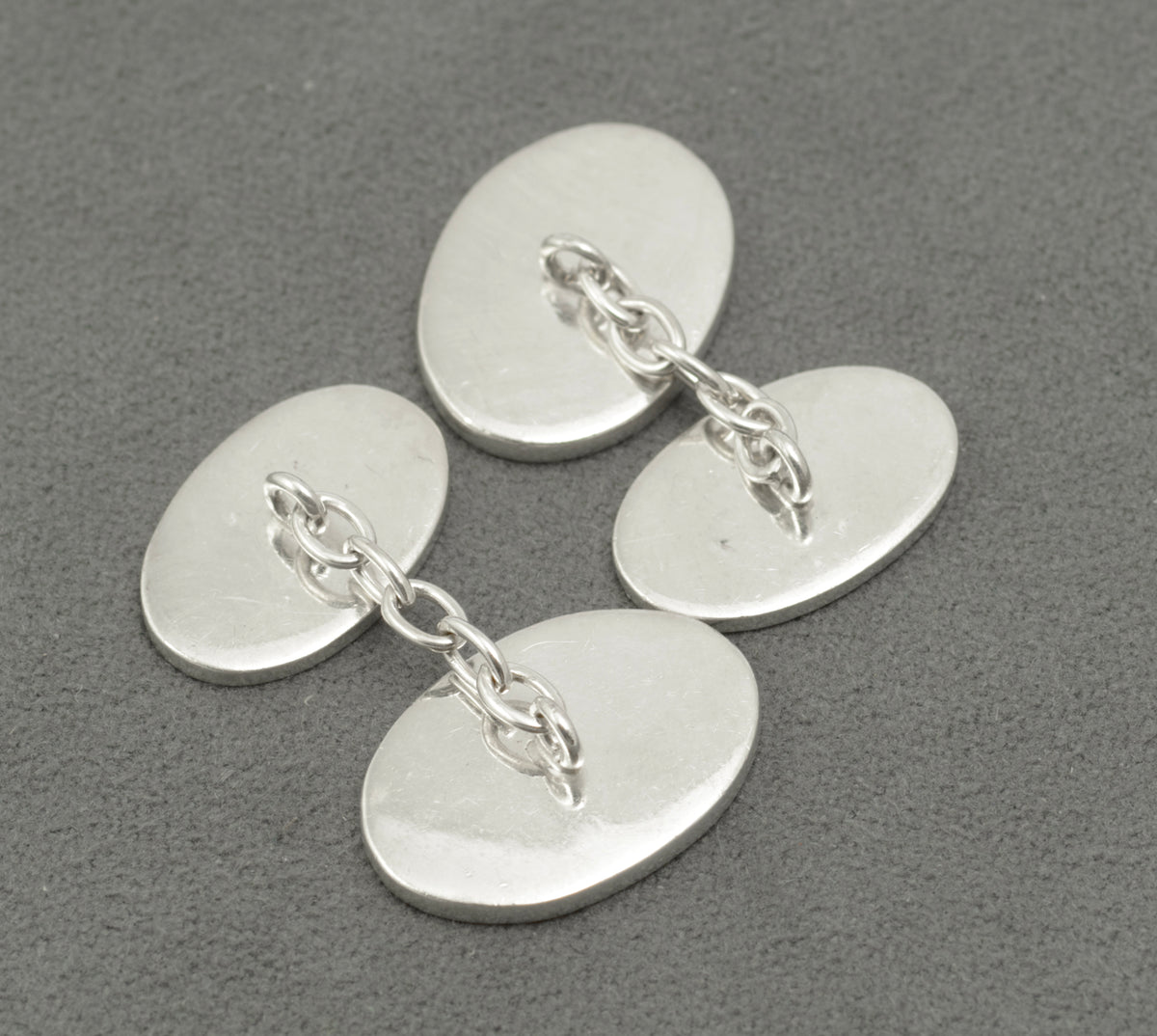 Front and reverse panels of the sterling silver cufflinks with their connecting chains