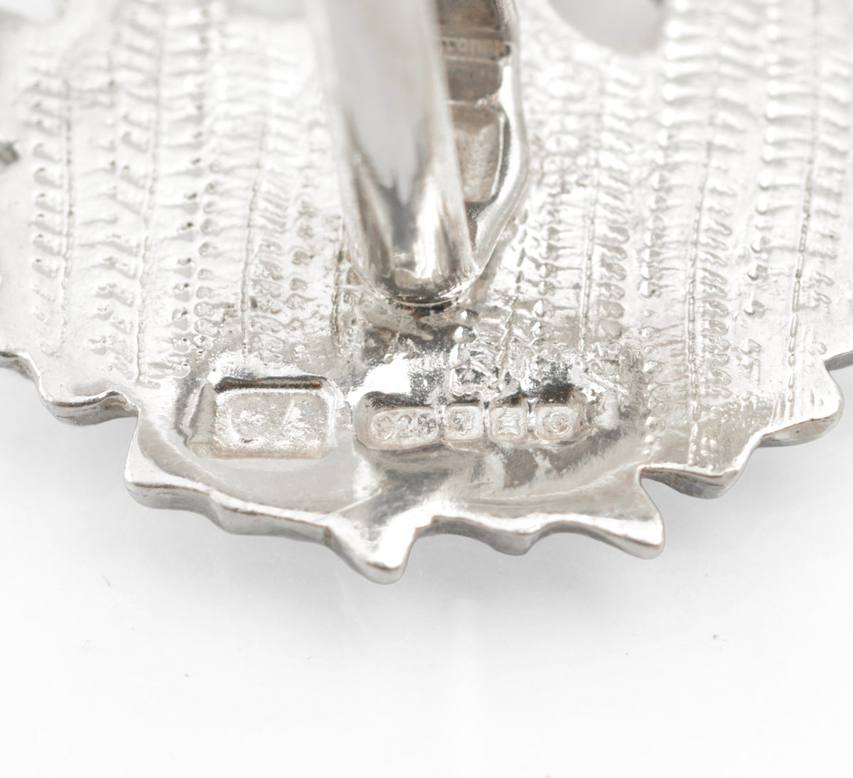 Close up of Edinburgh 2002 sterling silver hallmarks on a cufflink reverse