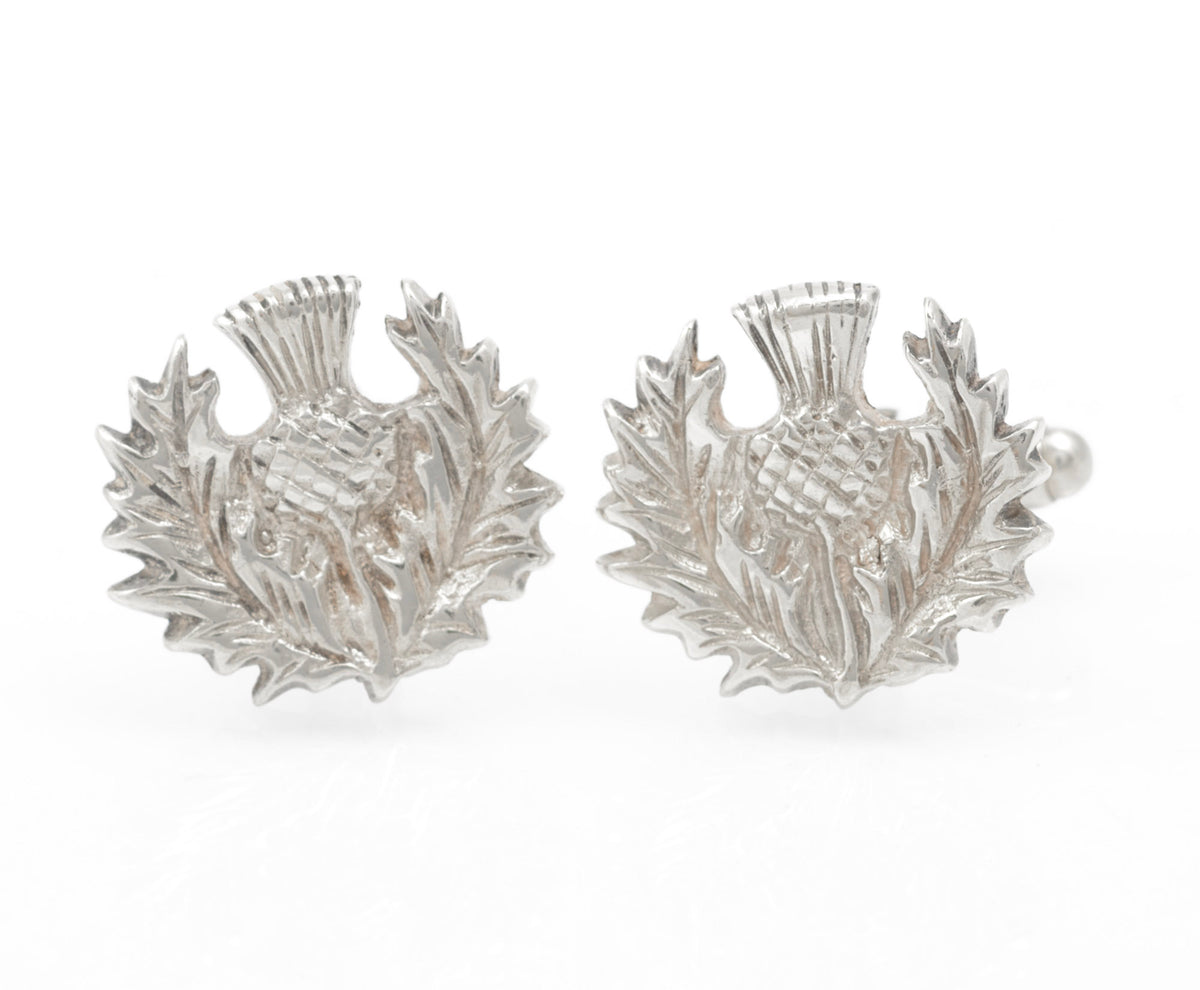A pair of Scottish sterling silver thistle cufflinks by Celtic Art Industries, hallmarked Edinburgh 2002. The fronts are cast in relief as traditional Scottish thistles, with rotating bar fittings to the reverse.