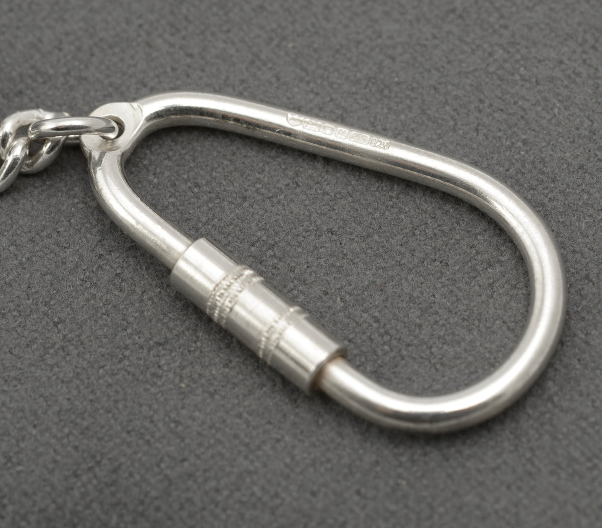 Close view of the karabiner style silver key holder with its screw barrel closed