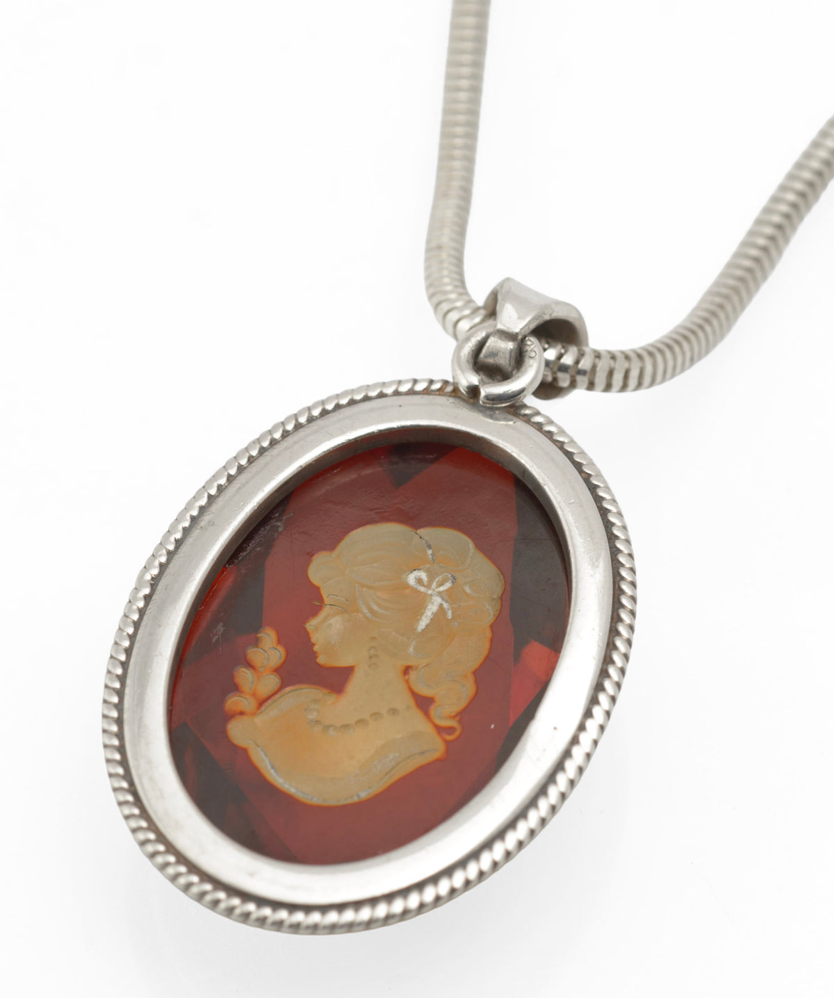 Faceted amber pendant with reverse carved female portrait and silver rope twist border