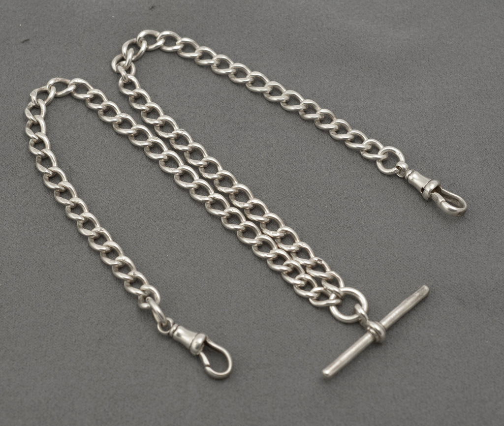 Edwardian silver double Albert watch chain coiled with central T bar and two swivel dog clips