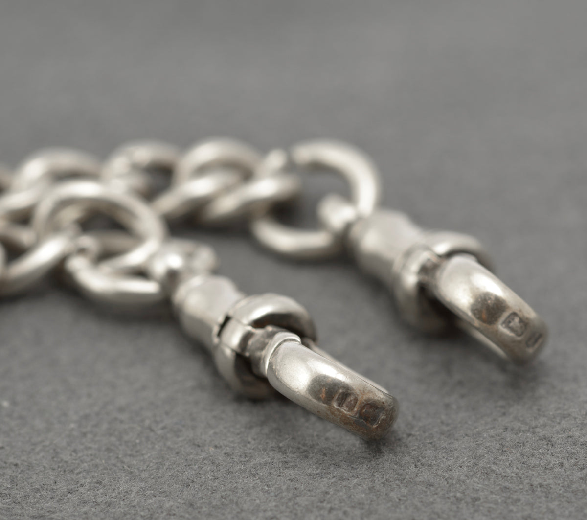 Hallmark and HP maker's mark on the silver T bar with adjoining curb links