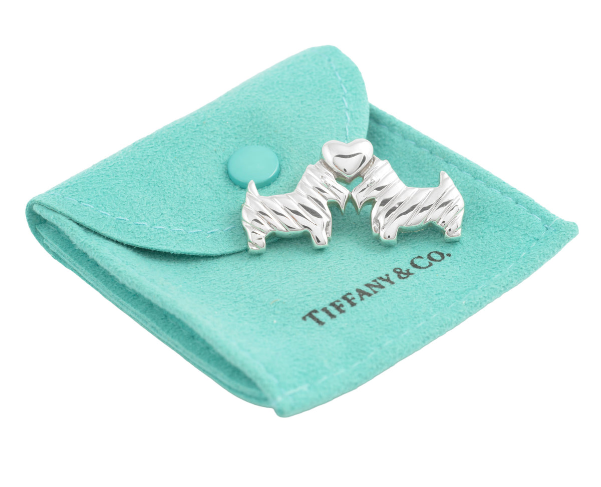 Tiffany silver Scottie dog brooch shown on its turquoise pouch