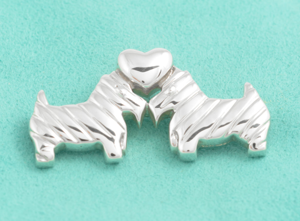 Close view of the textured Scottish Terriers and polished silver heart