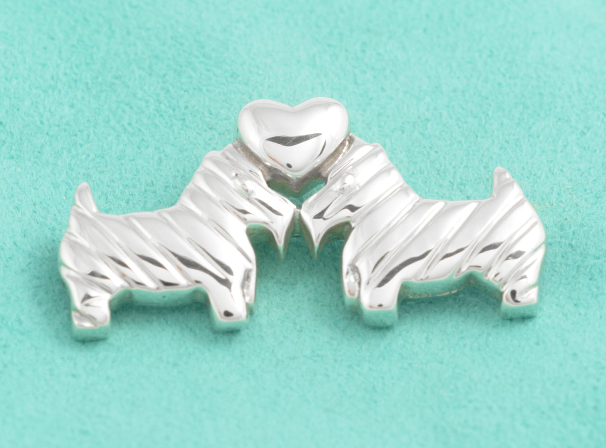 Close view of the textured Scottish Terriers and polished silver heart