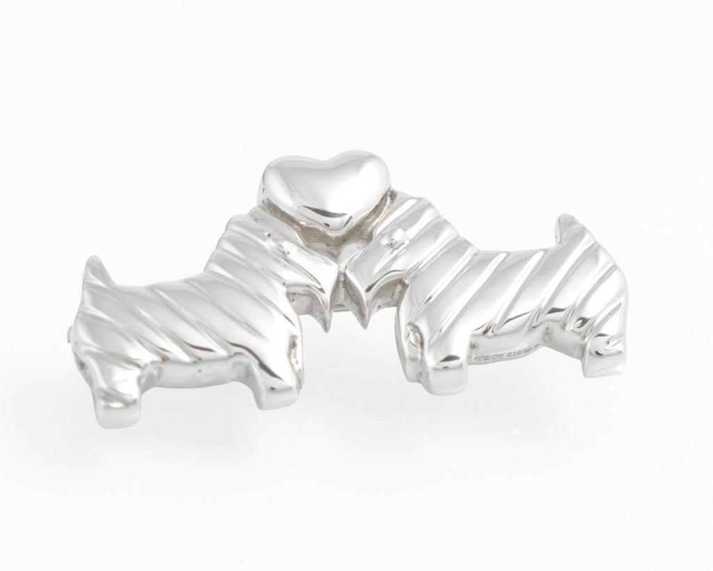 Front view of Tiffany sterling silver Scottie dog and heart brooch against white