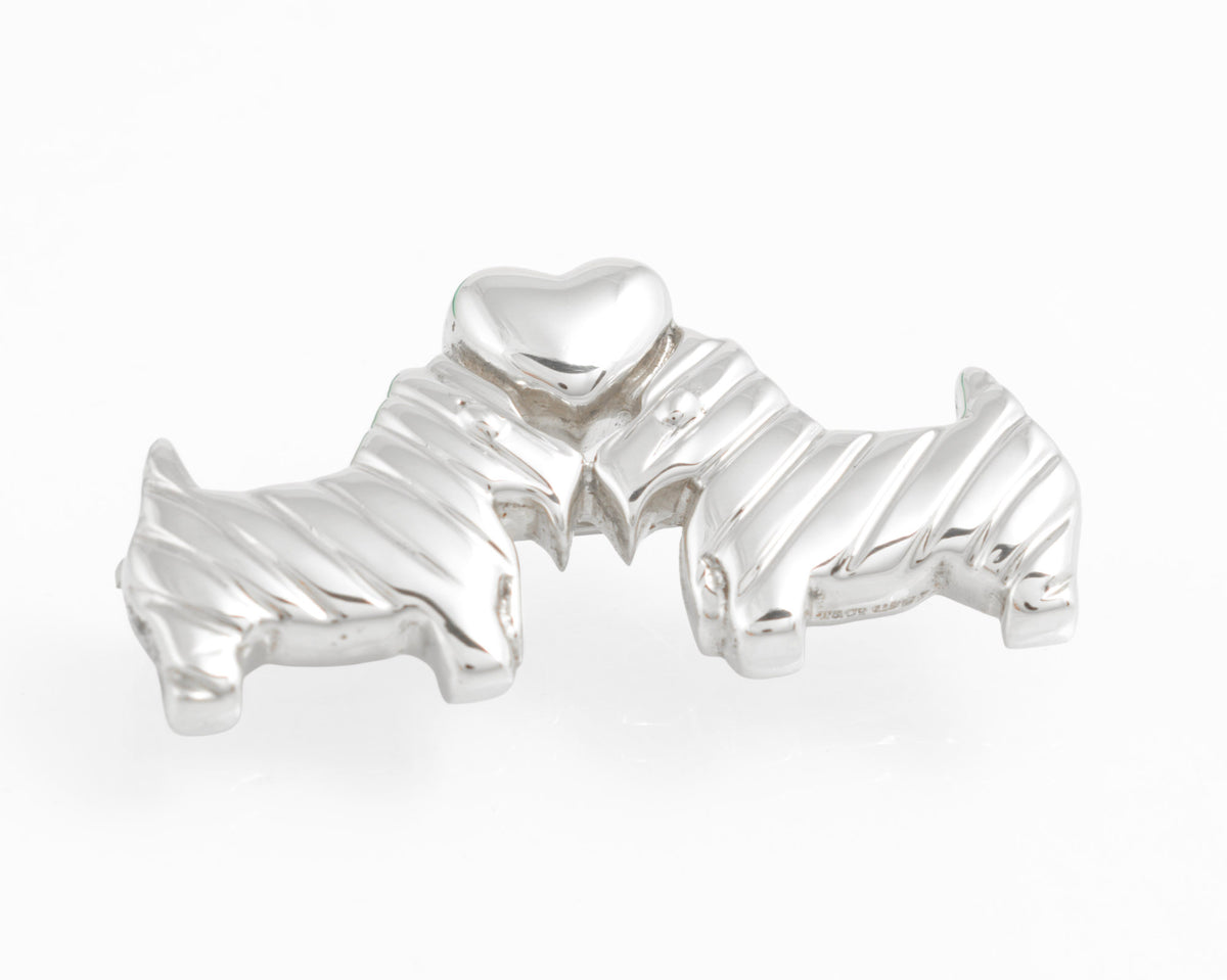Front view of Tiffany sterling silver Scottie dog and heart brooch against white
