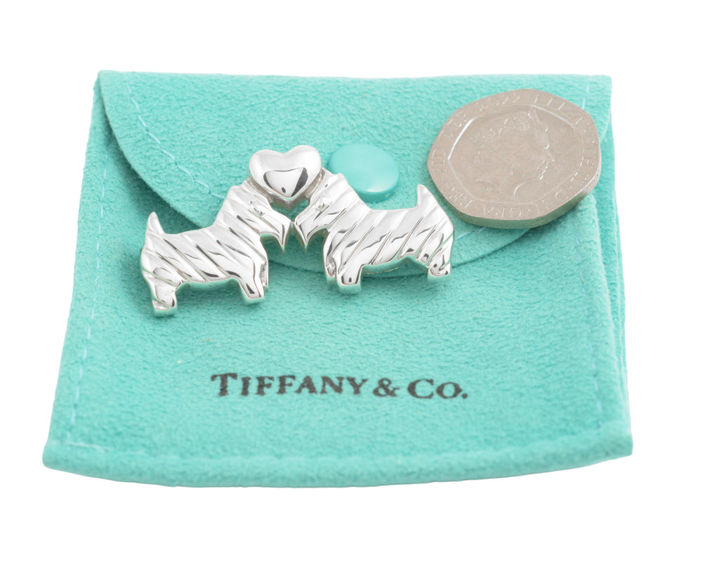 Tiffany Scottie dog brooch on pouch beside a coin for scale, coin not included