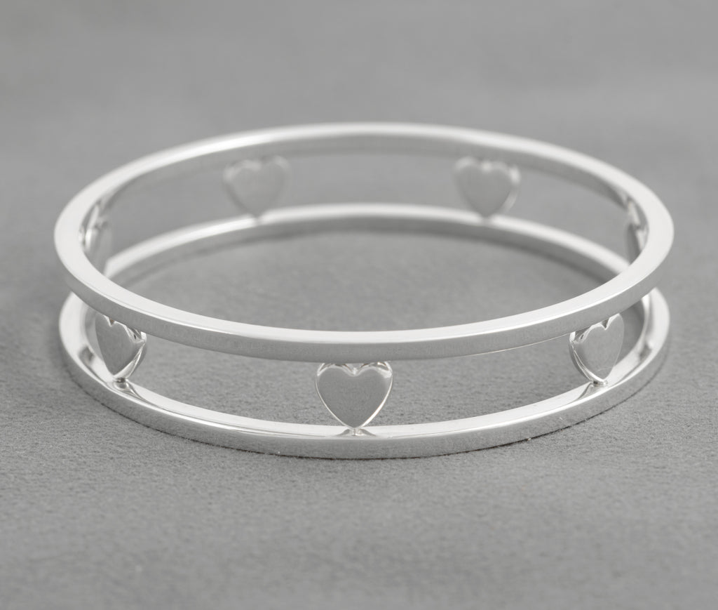 Tiffany Floating Heart silver bangle on grey background showing its open double rail construction
