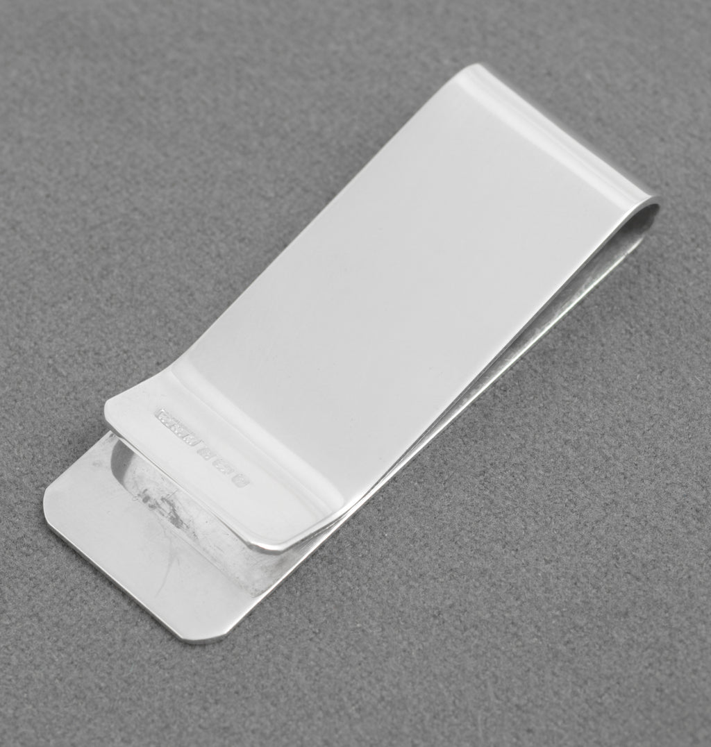 Front view of the silver money clip showing the plain engraving cartouche