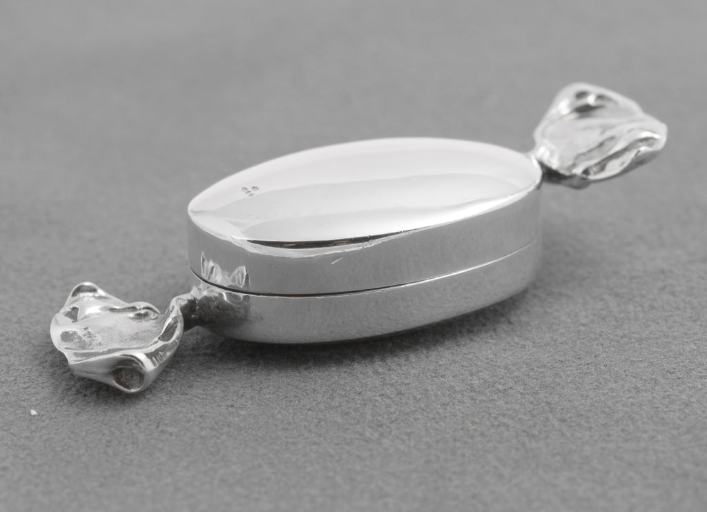Open silver sweet box showing the plain interior