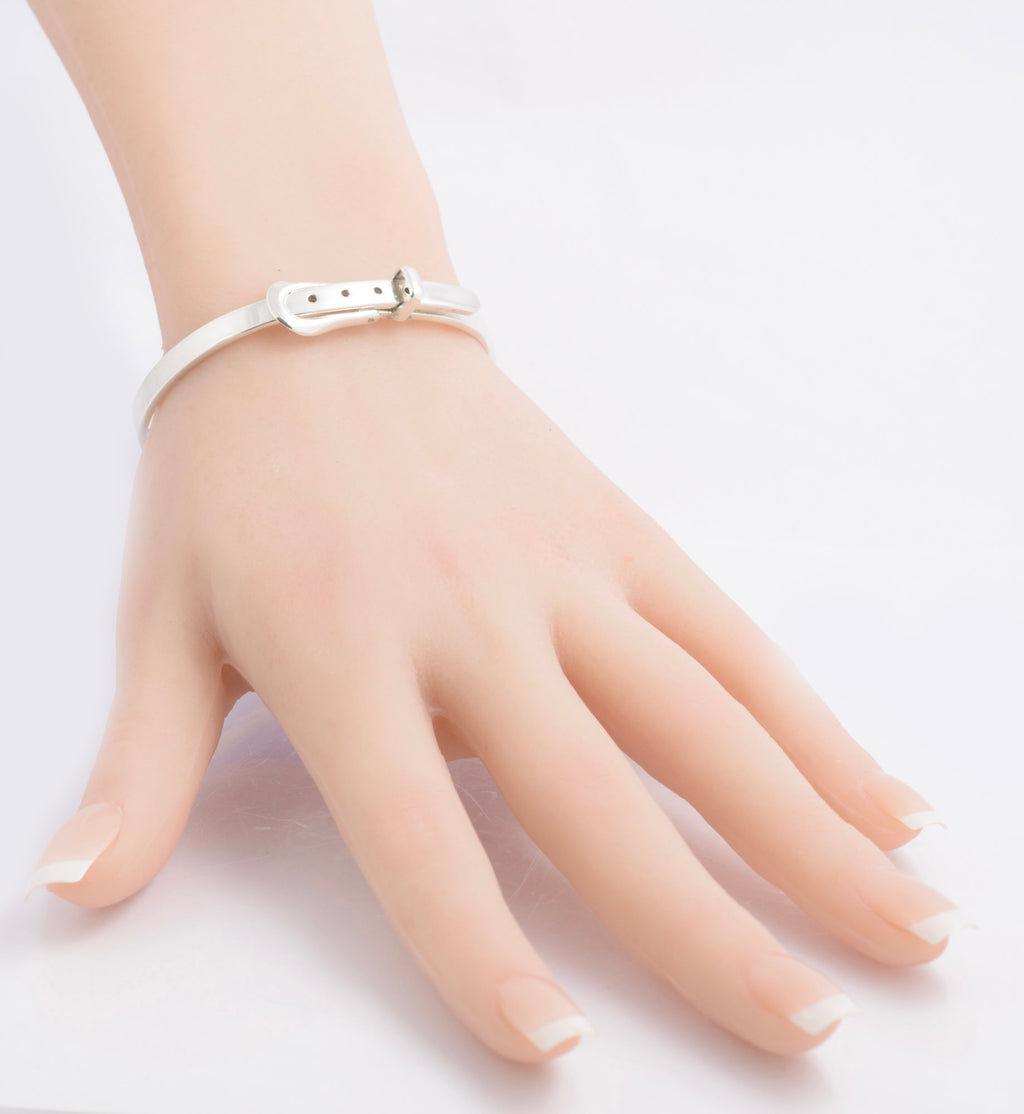 Mexican silver belt buckle bangle displayed on a model hand