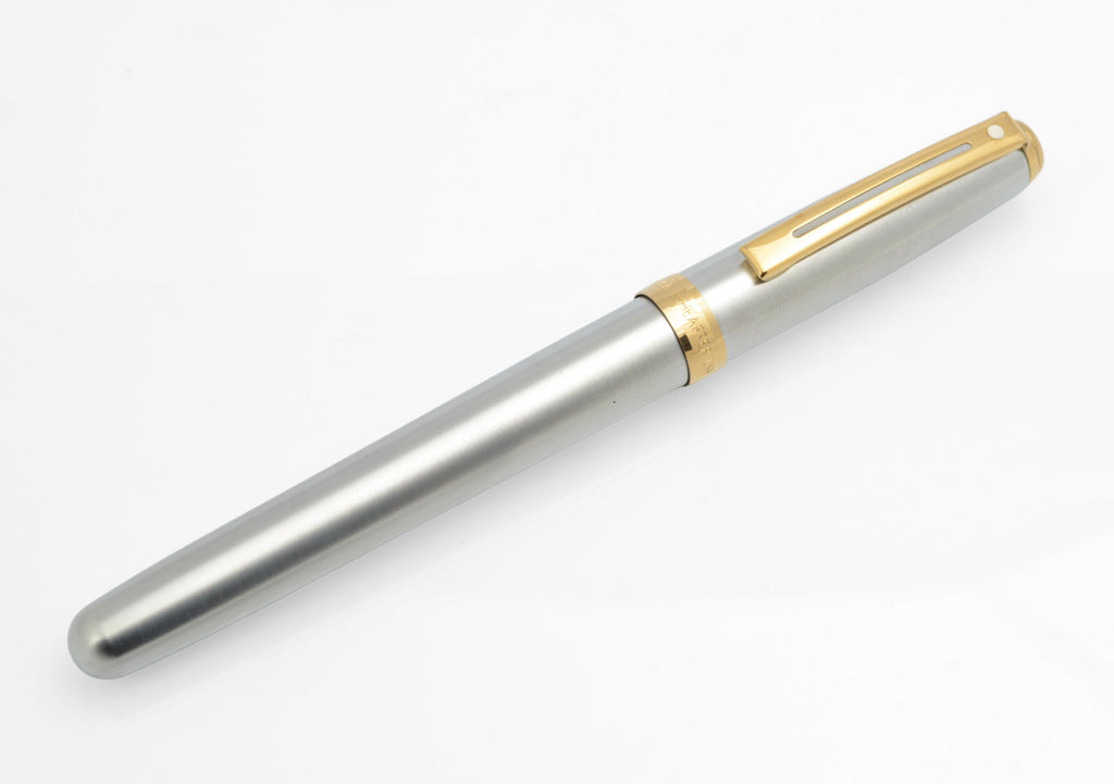 Capped Sheaffer Prelude fountain pen in brushed chrome with gold plated trim